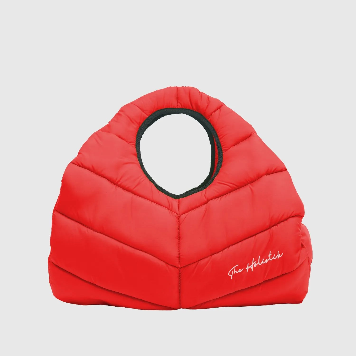 Amara Red Puffer Bag: Eye-catching and stylish puffer bag in vibrant red. Features a smart interior with a main compartment, zipper pocket, and two slide pockets for organized storage. Ideal for various activities, including gym, yoga, and travel, with a touch of elegance from THE HOLISIK embroidery.